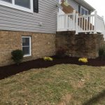 Exterior of house with mulch and shrubs