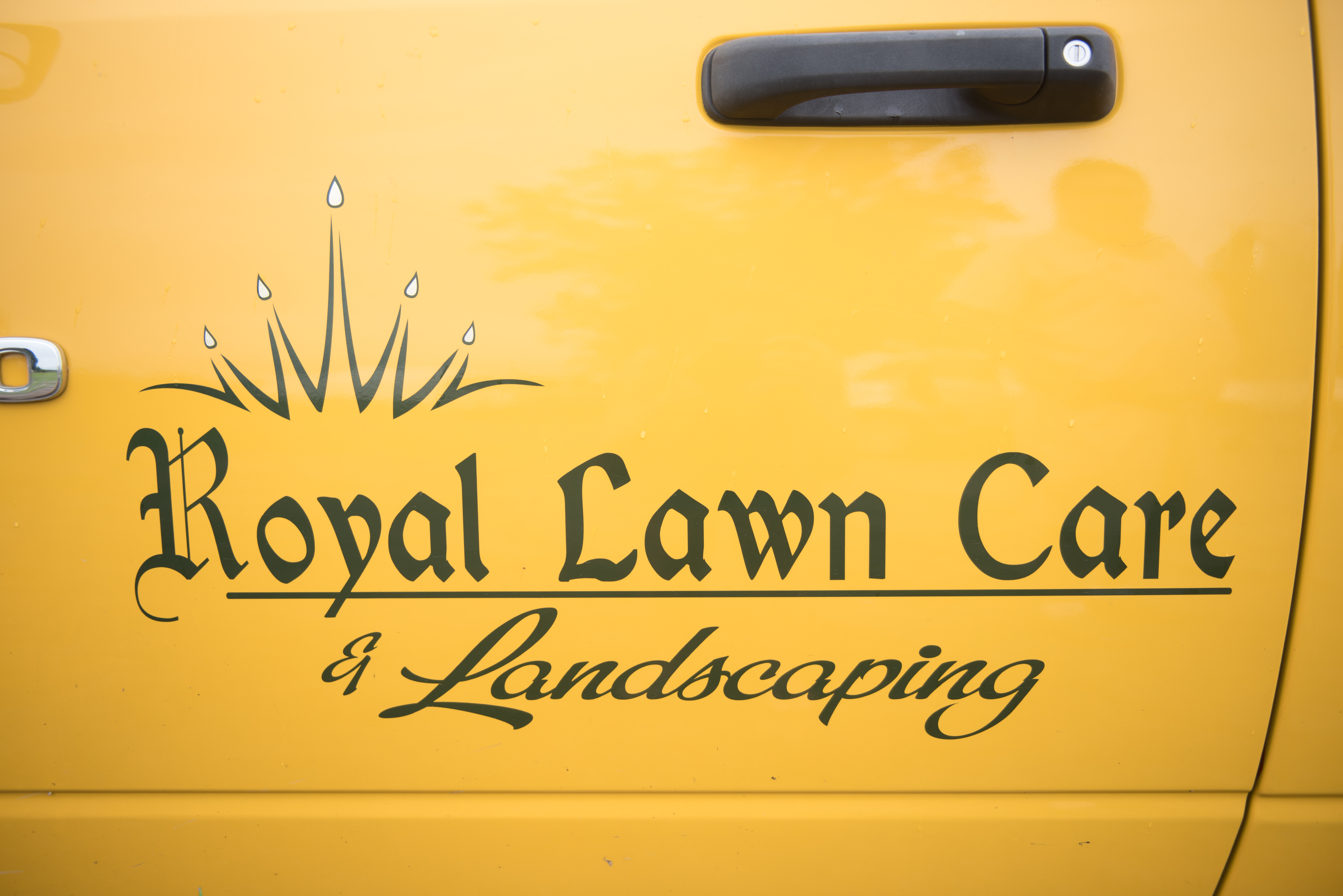 A logo for Royal Lawn Care on the side of a truck