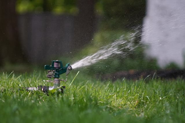 Impact sprinkler helping the spring lawn develop
