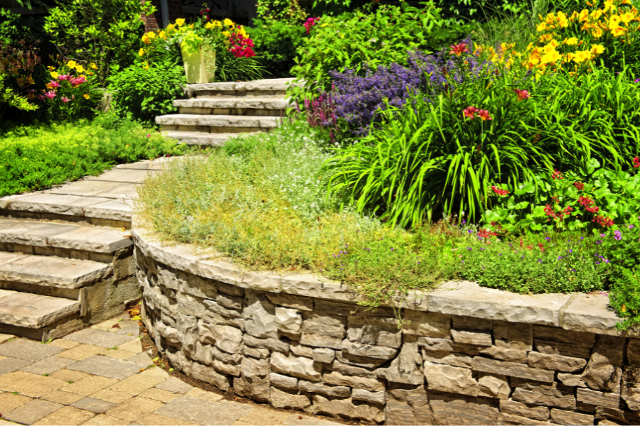 stone path and retaining wall in a flower garden