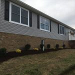 Large house exterior with brick foundation