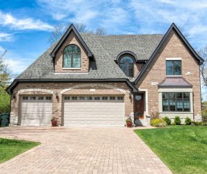 Front of a stone house with a stone driveway